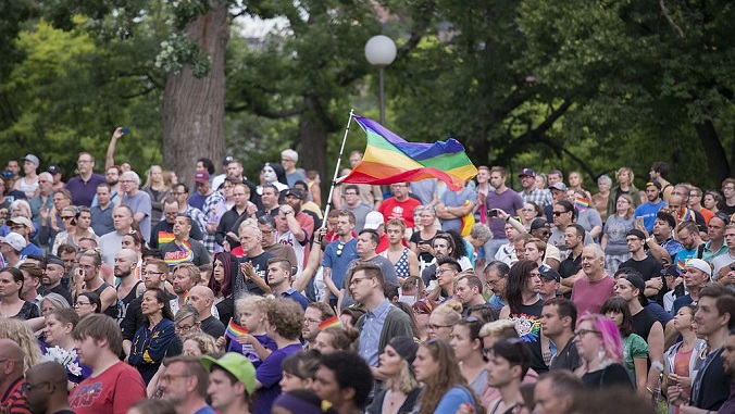 Mourners gather for a vigil for the victims of the Orlando Shooting.  Source.